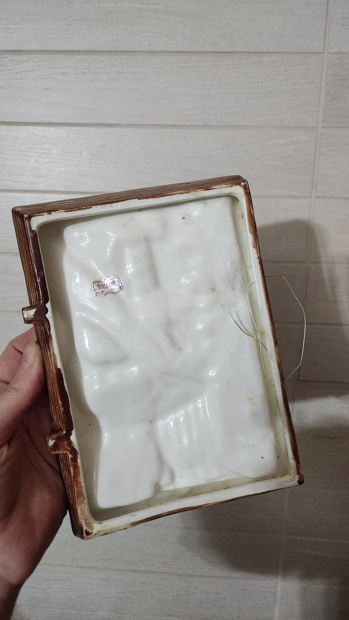 3D relief ceramic wall hanging depicting a hand-painted village scene