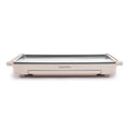 Clay-colored griddle with front-facing warming drawer and side handles, shown from the front.