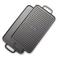 The Bobby Flay by GreenPan 9.5" x 16.5" Reversible Cast Iron Grill Griddle, with dual handles and smooth and ridged sides, is stacked at an angle—ideal for family-sized cooking.