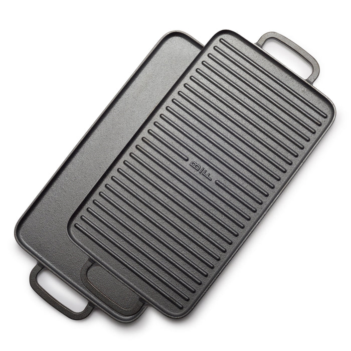 The Bobby Flay by GreenPan 9.5" x 16.5" Reversible Cast Iron Grill Griddle, with dual handles and smooth and ridged sides, is stacked at an angle—ideal for family-sized cooking.