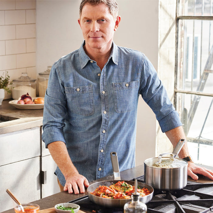 Two men stand in a kitchen beside GreenPan stainless steel nonstick frypans on the counter.
