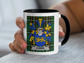 White mug with black handle featuring the Currie family crest on a tartan background.