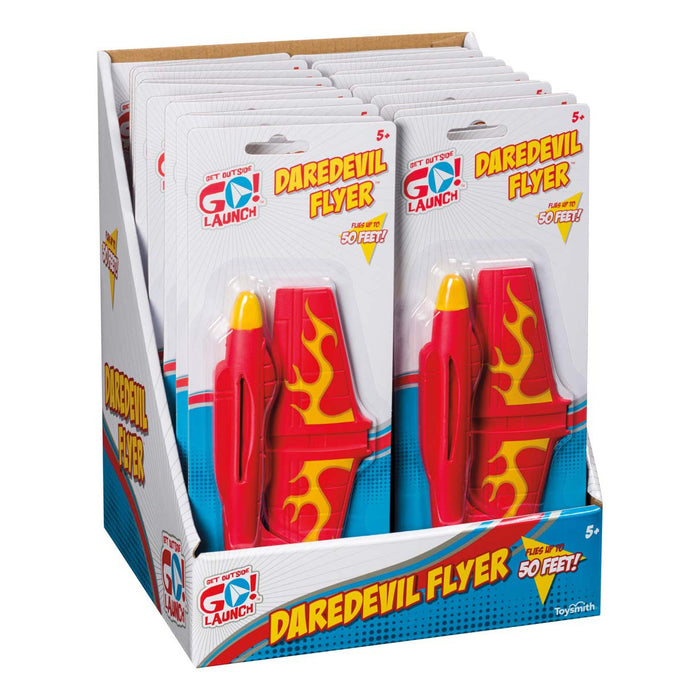 A display box holds multiple GO! Launch Daredevil Flyer airplanes by GO! Launch, featuring red bodies with yellow flames and “Flies over 50 feet!” on the packaging. These stunt launcher toys are ideal for outdoor play for kids ages 5 and up.