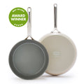 Two taupe ceramic frypans with mirror-finish handles, shown as a 9.5-inch and 11-inch hard anodized set.