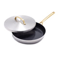 Stainless steel 12-inch frypan with lid, champagne-colored handles, lid partially open on a white background.