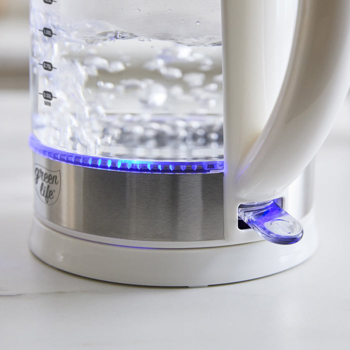 White glass electric kettle with 1.7L capacity and blue LED base lighting, water visibly boiling inside.