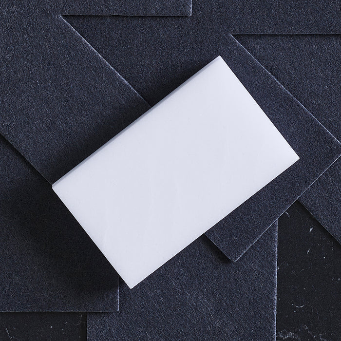 GreenPan melamine sponges, 2-pack, shown on dark textured cards with a white card beside them.