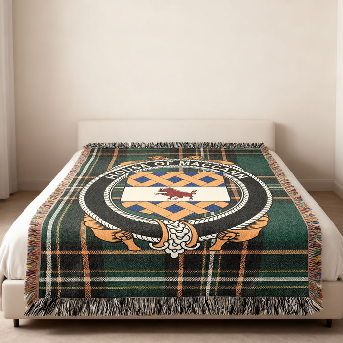 House of MacCann woven blanket spread across a bed in a neutral bedroom