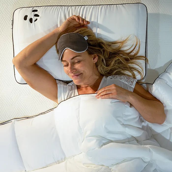 [HybridPillow] Hybrid_Bamboo_Pillow_-_Woman_laying_on_a_Hybrid_Bamboo_Pillow_with_an_Eye_Mask