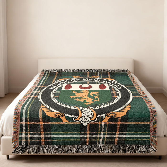 MacCartan family crest emblem woven blanket displayed on a bed