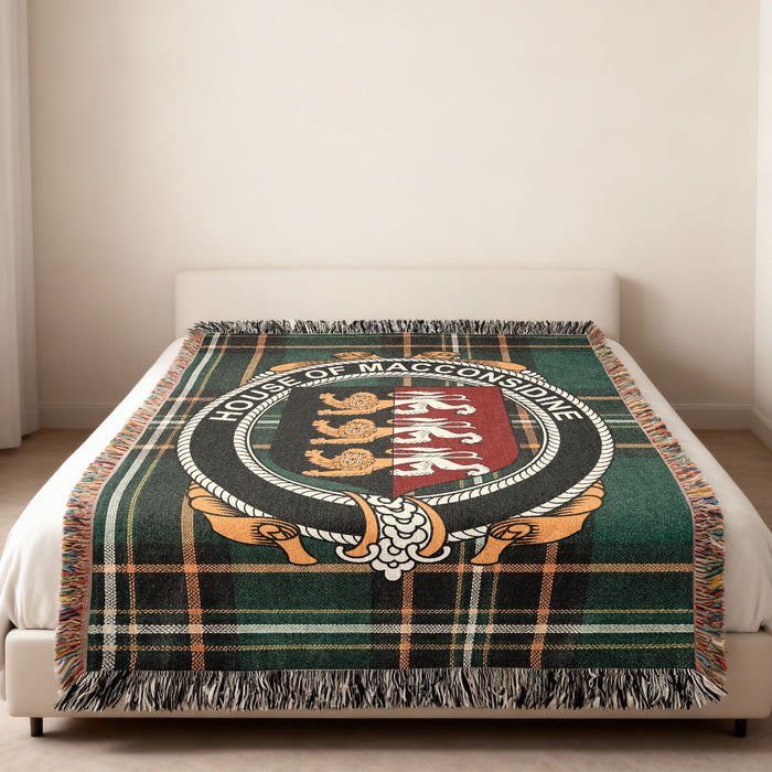 MacConsidine family crest emblem woven blanket displayed on a bed
