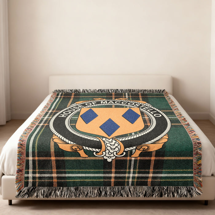 MacCostello family crest emblem woven blanket displayed on a bed