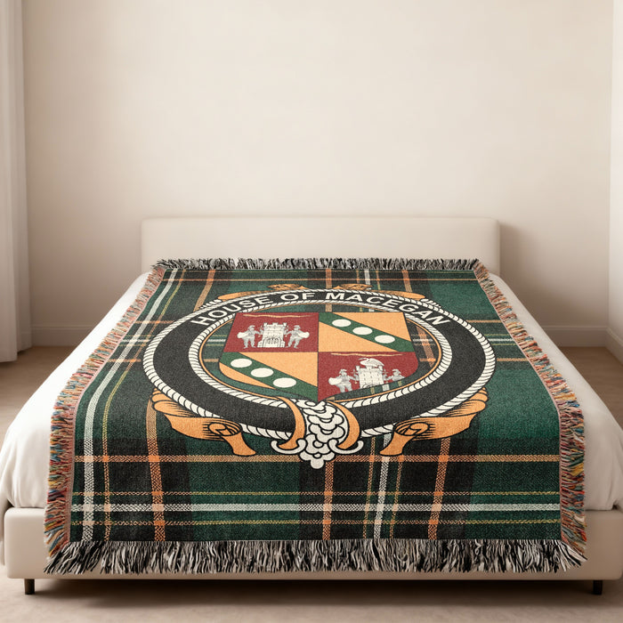 MacEgan family crest emblem woven blanket displayed on a bed