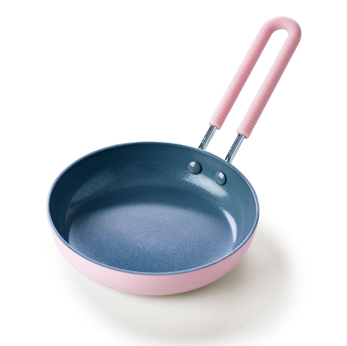 Small pink ceramic nonstick frypan with a 5-inch diameter and handle, shown on a plain background.