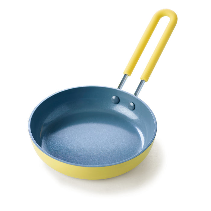 Yellow ceramic nonstick 5-inch frypan with blue interior and handle, displayed on a white background.