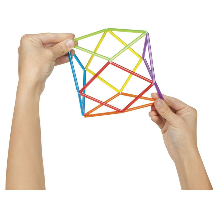Two hands hold the On the Way Games Geo Twister by On the Way Games—a colorful, interconnected plastic fidget toy in red, orange, yellow, green, blue, and purple for stress relief or sensory play—against a white background.