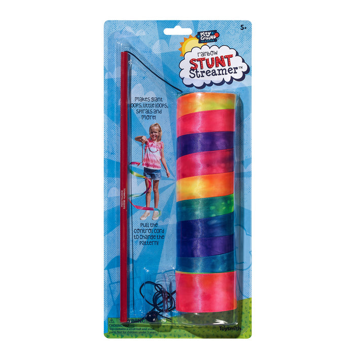 The Playground Classics Rainbow Stunt Streamer features a colorful ribbon, red wand, and control cord—ideal for outdoor play. Its packaging shows a child in creative motion and highlights key features. Suitable for ages 5+.