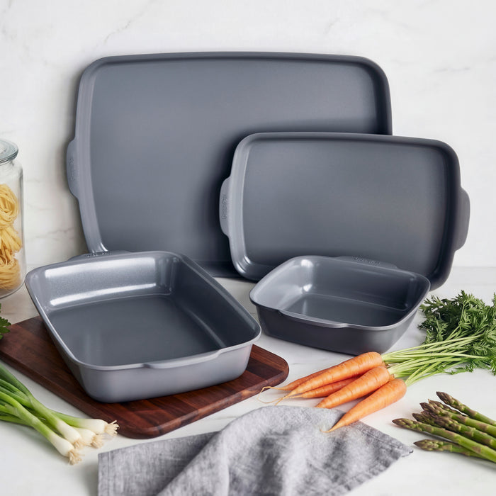 Gray ceramic nonstick 4-piece ovenware set on a table with assorted vegetables.