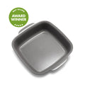 Gray ceramic square baker with nonstick finish next to a green award badge featuring stars.