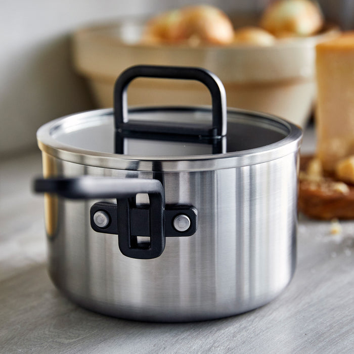 Stainless steel 2-quart saucepan with ceramic nonstick coating and lid on a countertop.