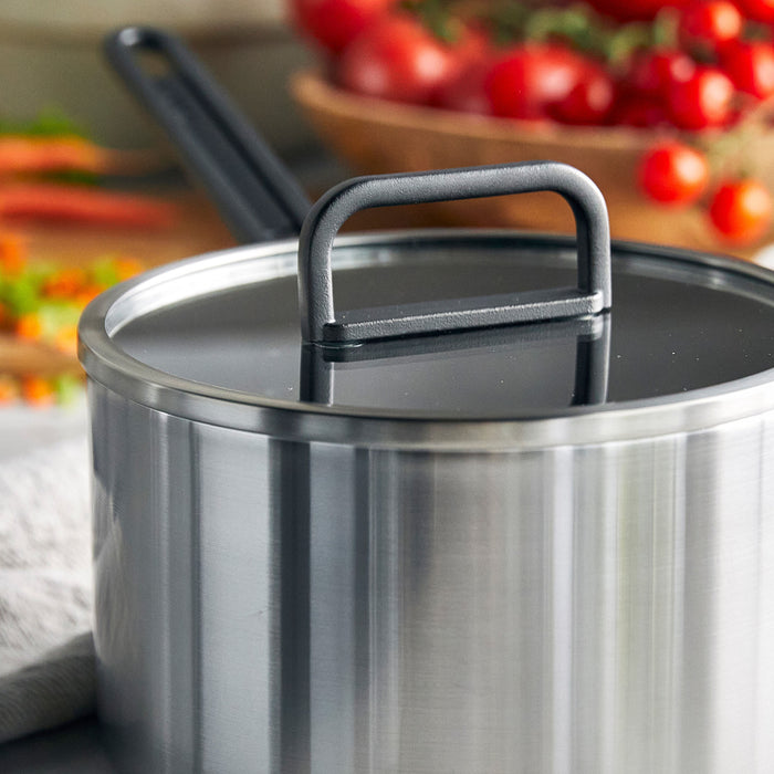 Stainless steel saucepan with ceramic nonstick coating and lid on a kitchen counter, 4-quart size.