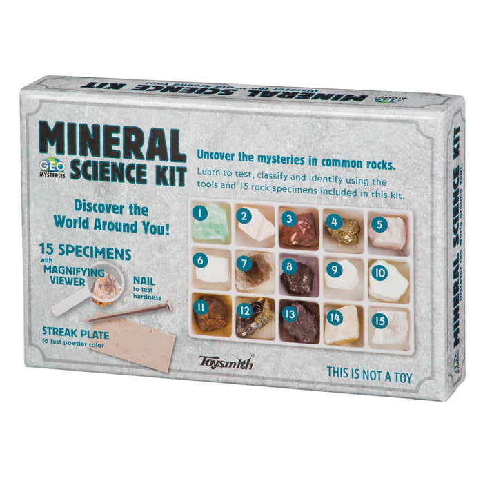 The Toysmith Mineral Science Kit by Toysmith includes 15 rock and mineral specimens in a grid, a magnifying viewer, nail, and streak plate. The box explains this STEM kit helps kids test, classify, and identify common rocks.