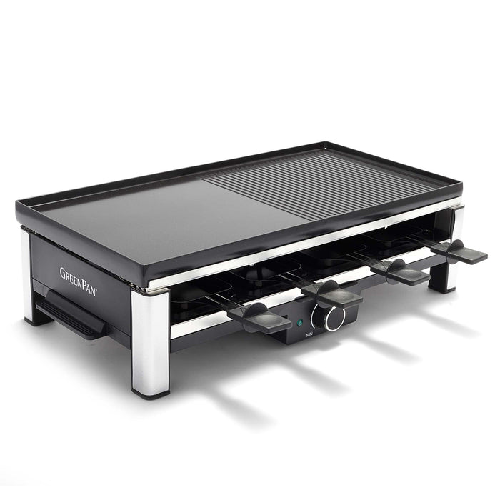 Rectangular cast aluminum grill with both grill and griddle surfaces, shown with eight spatulas underneath.