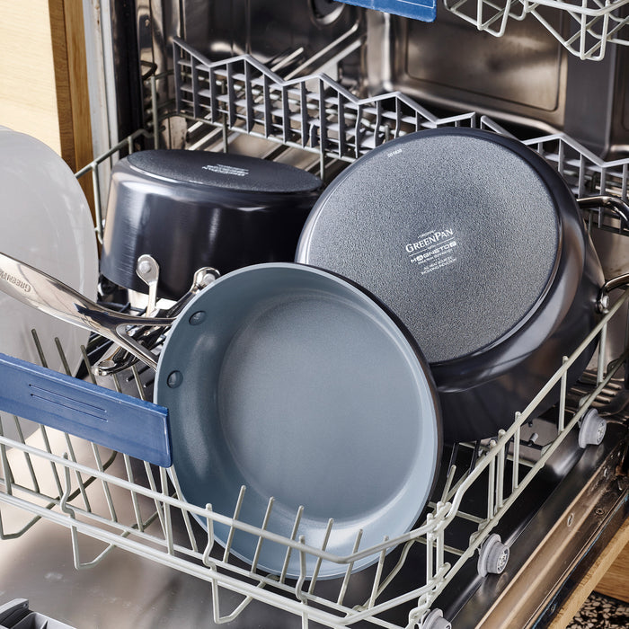 Square ceramic nonstick griddle in gray on the bottom rack of an open dishwasher.