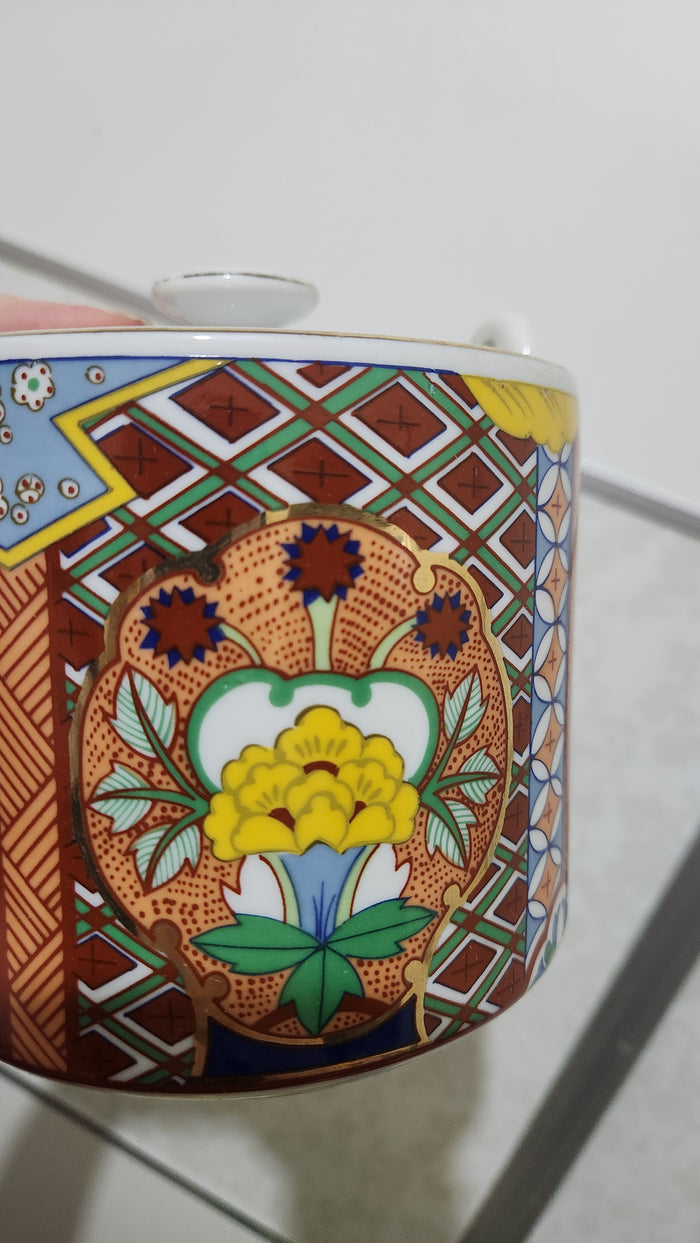 Vintage Japanese Imari ware porcelain teapot with a wicker handle