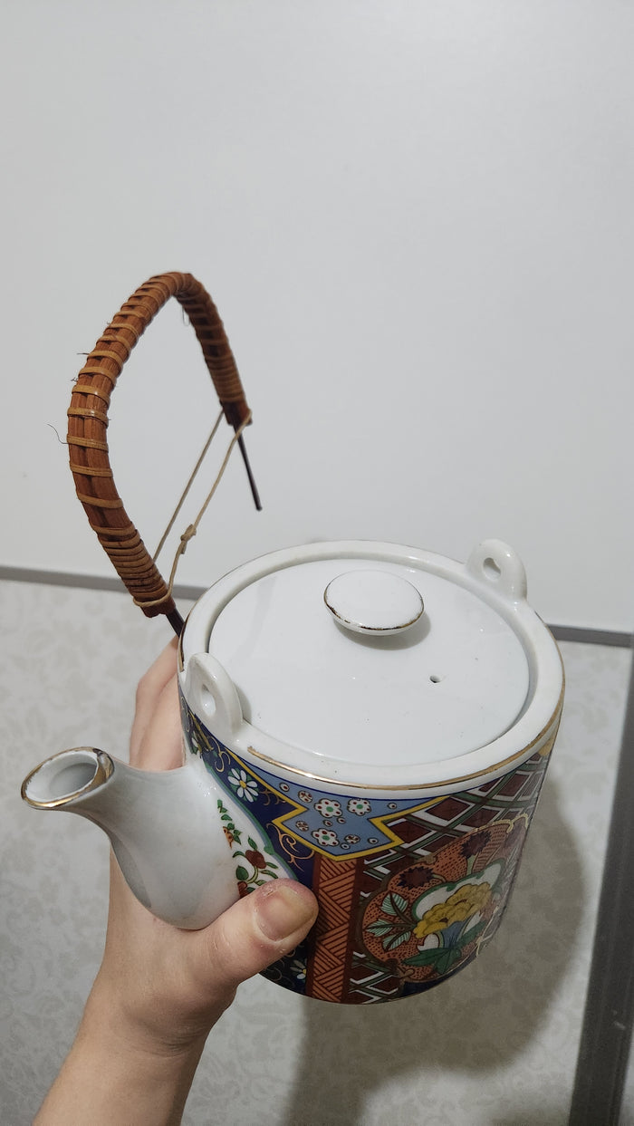 Vintage Japanese Imari ware porcelain teapot with a wicker handle