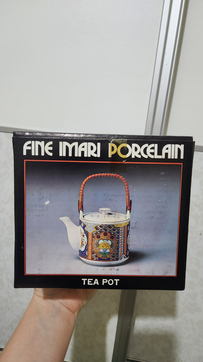 Vintage Japanese Imari ware porcelain teapot with a wicker handle