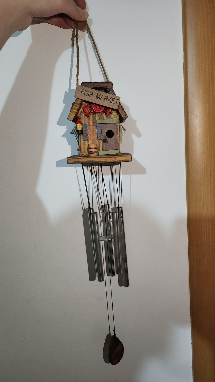 wooden house-shaped wind chime with metal tubes