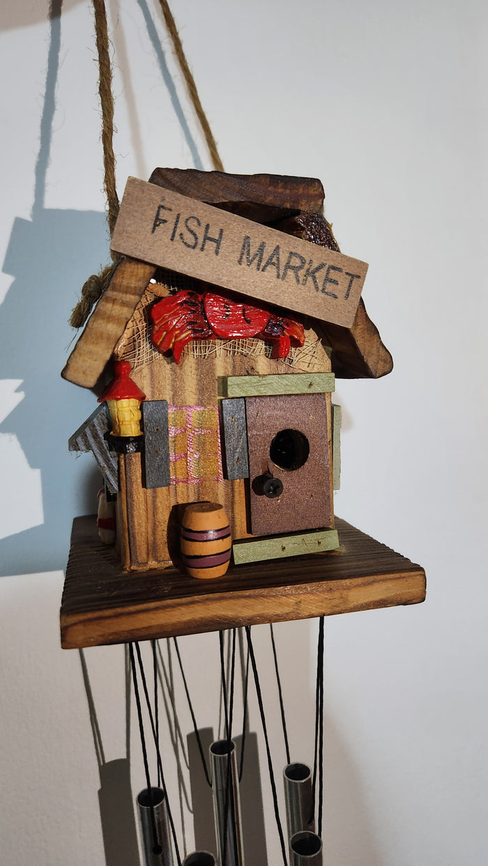 wooden house-shaped wind chime with metal tubes